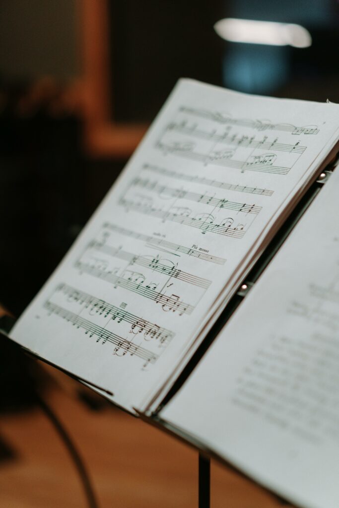 pexels-photo-7086303-7086303 Detailed view of open sheet music in a music studio setting, emphasizing musical notes.